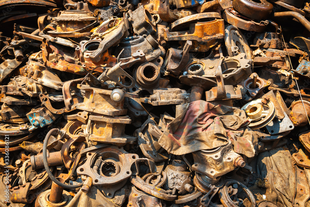 Pile of old rusty metal scrap, used machine spares and car parts can be used as mechanic industrial background Pile of old rusty metal scrap, used machine spares and car parts can be used as mechanic industrial background