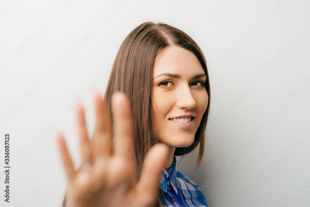 Girl showing stop sign isolated on white Girl showing stop sign isolated on white