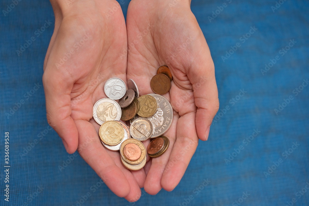 Retro coins from various countries of the world in the hands of a young woman Retro coins from various countries of the world in the hands of a young woman