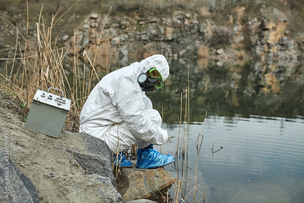 Girl in protective overalls on the nature. Biological protection suit. Personal protective equipment to prevent transmission of the virus. The concept of coronavirus, pandemic, flu and quarantine. Girl in protective overalls on the nature. Biological protection suit. Personal protective equipment to prevent transmission of the virus. The concept of coronavirus, pandemic, flu and quarantine.