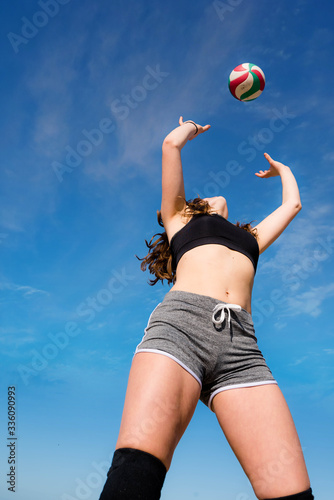 pretty young athletic woman doing beach volleyball © Image'in