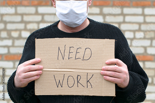 Canvastavla concept unemployment and coronavirus a man in a medical hygienic mask is holding