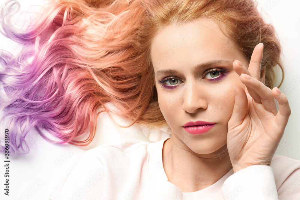 Portrait of young woman with dyed long curly hair on white background Portrait of young woman with dyed long curly hair on white background