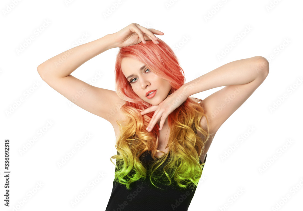 Portrait of young woman with dyed long curly hair on white background