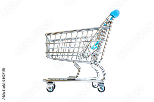 Empty shopping cart close-up isolated on a white background. Consumerism, sale and shopping concept.
