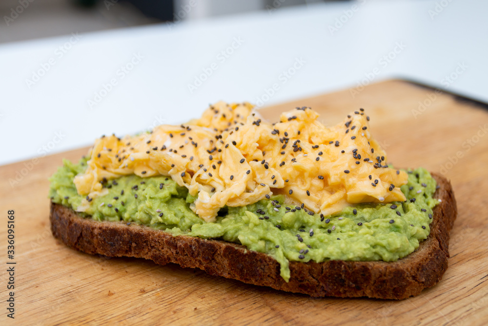 whole wheat toast with guacamole and omelette on top of a wood whole wheat toast with guacamole and omelette on top of a wood