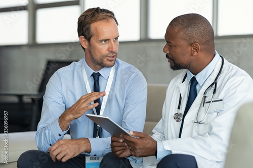Doctor in conversation with pharmaceutical representative photo