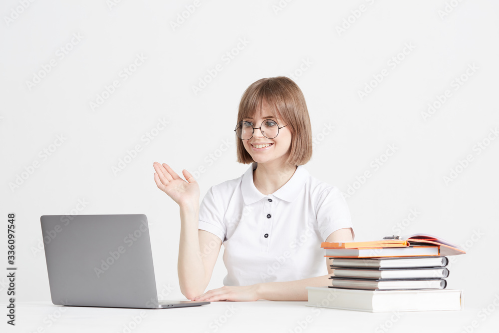 Cool happy girl goes through online training sitting at home. Remote school education on a laptop. Stay home lessons. Cool happy girl goes through online training sitting at home. Remote school education on a laptop. Stay home lessons.