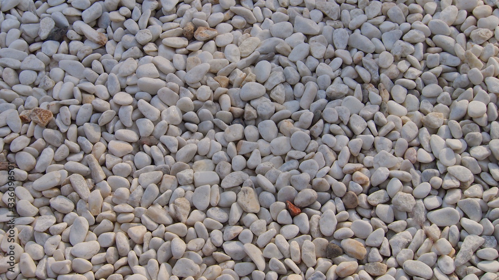 Small white rock pebbles . Natural background(texture) of white stones. Small white rock pebbles . Natural background(texture) of white stones.