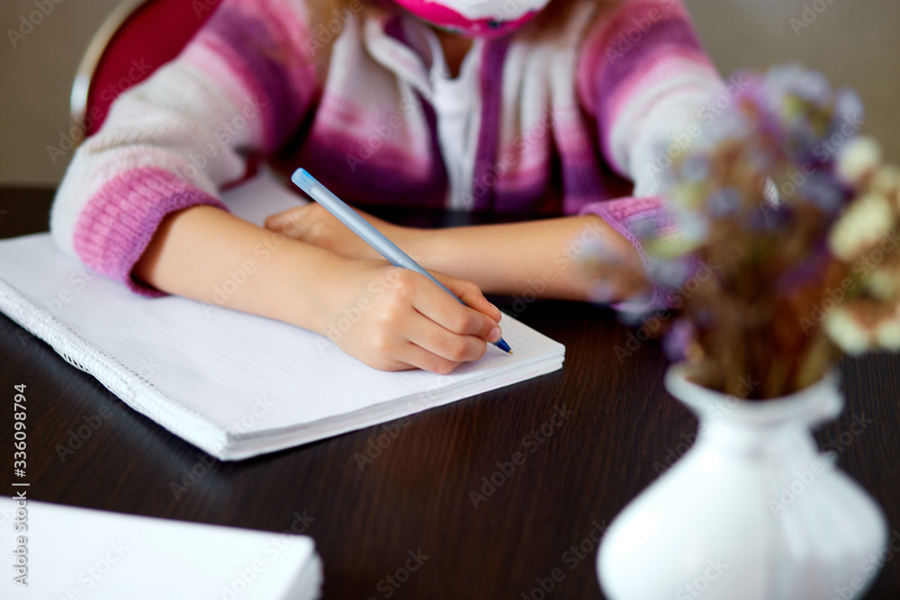 Unrecognizable girl doing homework, writing education concept, Coronavirus Unrecognizable girl doing homework, writing education concept, Coronavirus