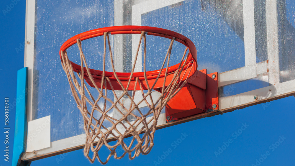 Close-up view of the metal hoop on transparent basketball board