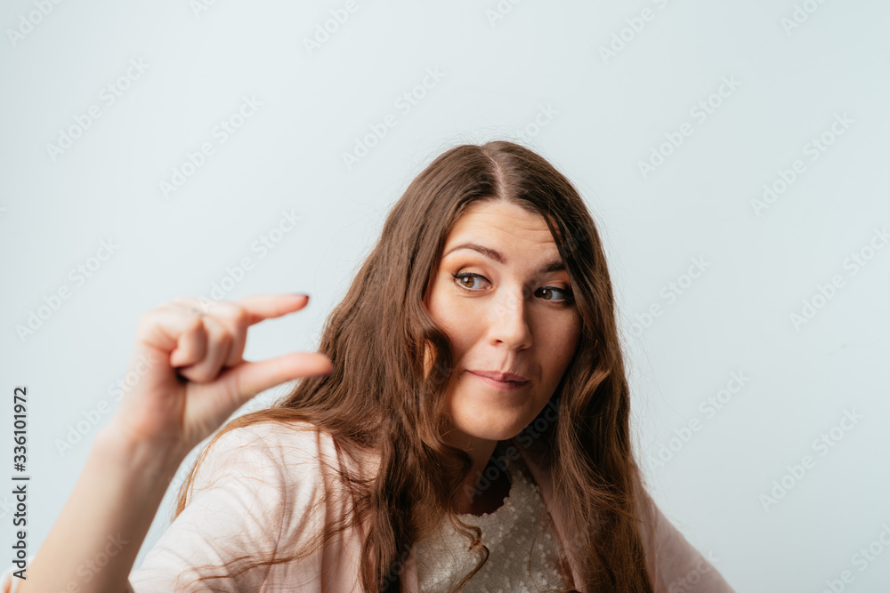 on a gray background young girl holding something invisible on a gray background young girl holding something invisible