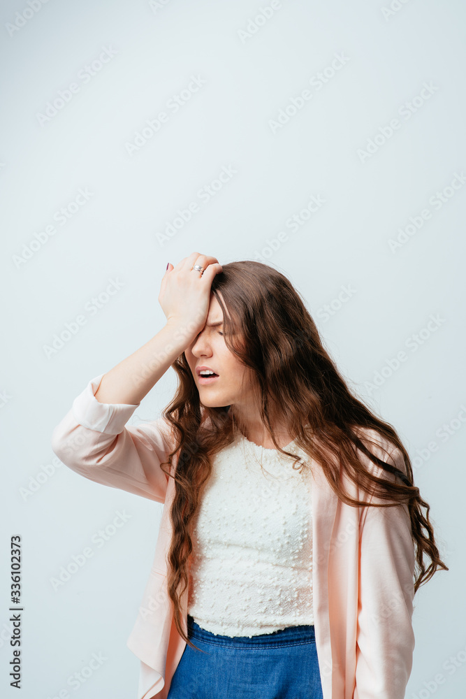 on a gray background young girl in chagrin on a gray background young girl in chagrin