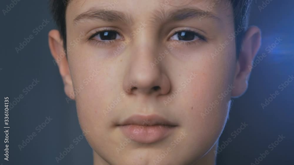 Close-up portrait of cute of 10 ages boy looking at camera at home in the evening Close-up portrait of cute of 10 ages boy looking at camera at home in the evening