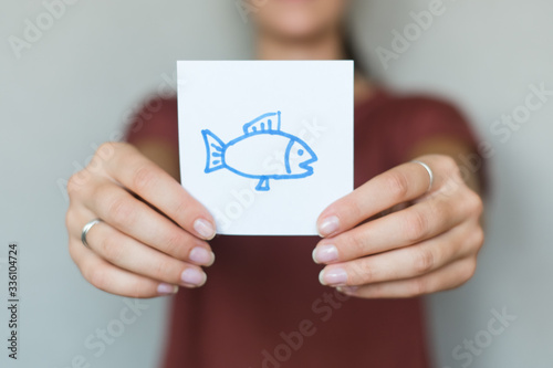 Picture icon in the hands of fish