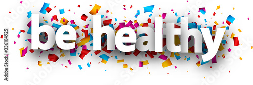 Small letters be healthy sign over confetti.