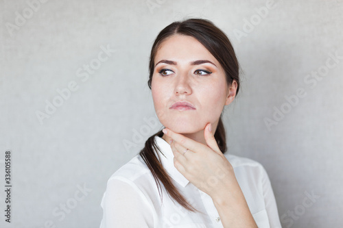 Portrait of a beautiful young woman thinking