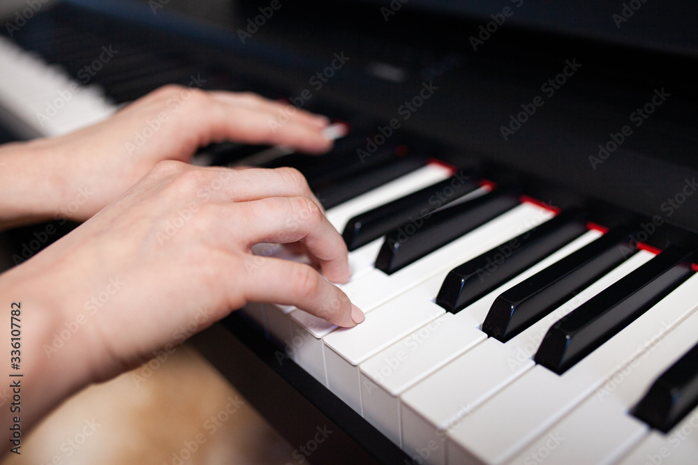 Woman hand's playing on the piano close up Woman hand's playing on the piano close up