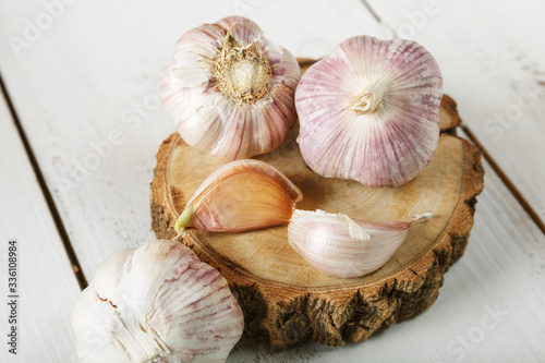 garlic on a wooden stand and white background 