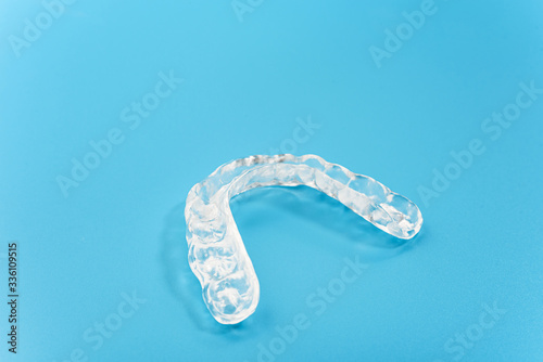 Dental aligner used by dental doctors isolated on blue background.