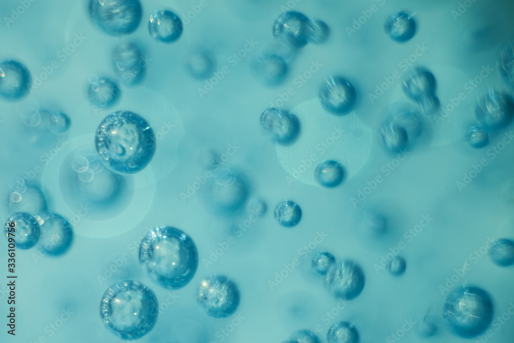 Many round bubbles of the shower gel on the blue background. Many round bubbles of the shower gel on the blue background.