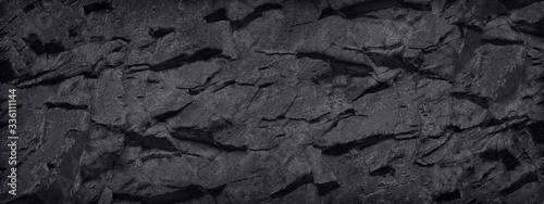 Black and white background. Stone texture. Black grunge background. Black banner with rock texture.