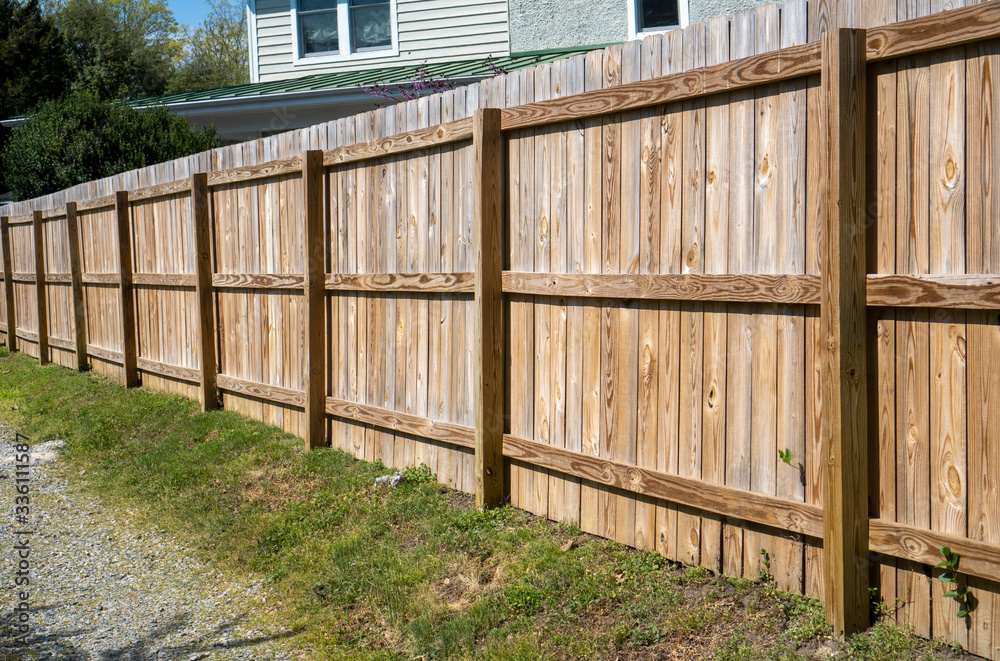 Newly constructed backyard fence facing alley.