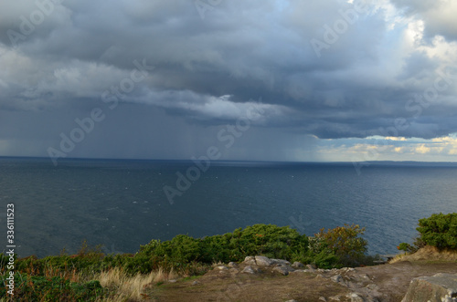 It rains in the sea all over the horizon © foxlikefox