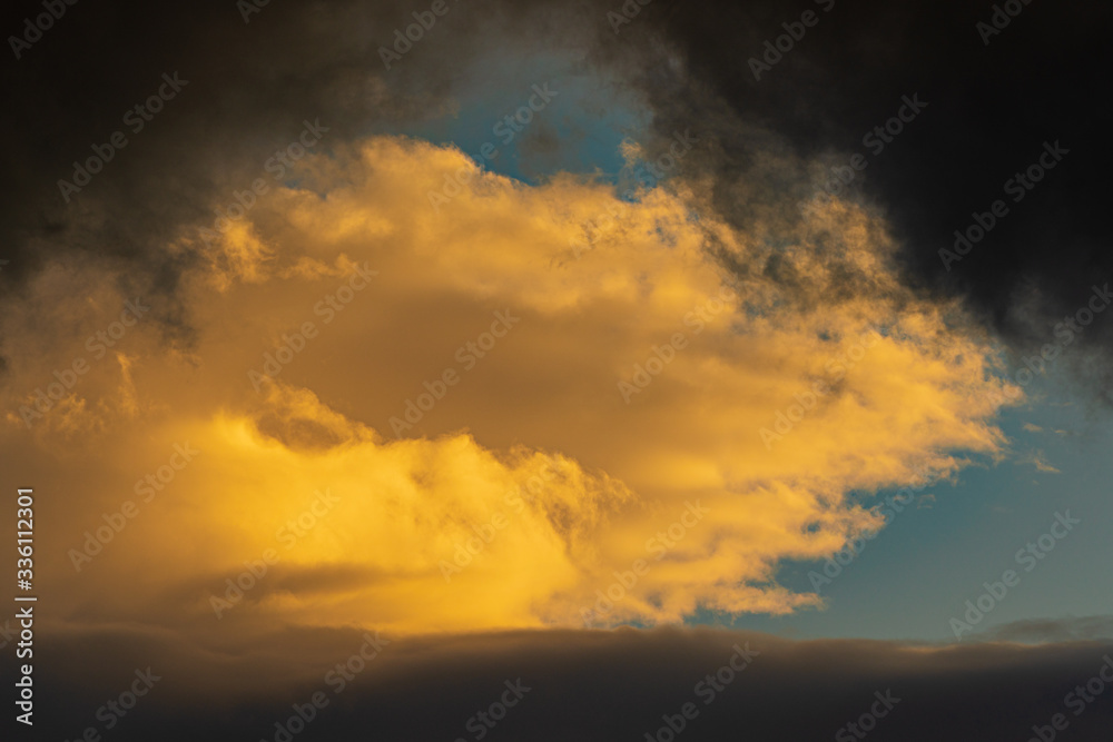 Dramatic clouds illuminated rising of sun floating blue sky. Natural weather, meteorology background. Heavenly landscape image ready for design, replace sky in photo editor. Soft focus, blurred motion
