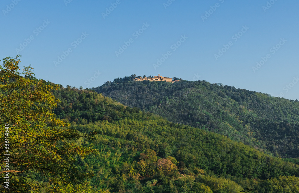The monastery Eremo del Monte Rua on the top of the hill. Italy. Soft focus, blurry background.