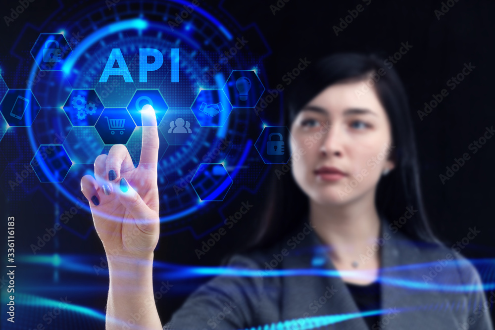 Business, Technology, Internet and network concept. Young businessman working on a virtual screen of the future and sees the inscription: API Business, Technology, Internet and network concept. Young businessman working on a virtual screen of the future and sees the inscription: API