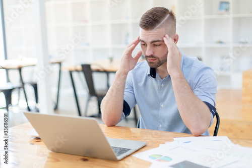 The man are stressed at work in the office. businessman stressful and headache with laptop computer. Young male with headache at office, feeling sick at work.