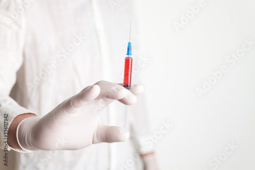 Syringe for medical injection in doctor's hand. Medicine plastic vaccination equipment with needle. 