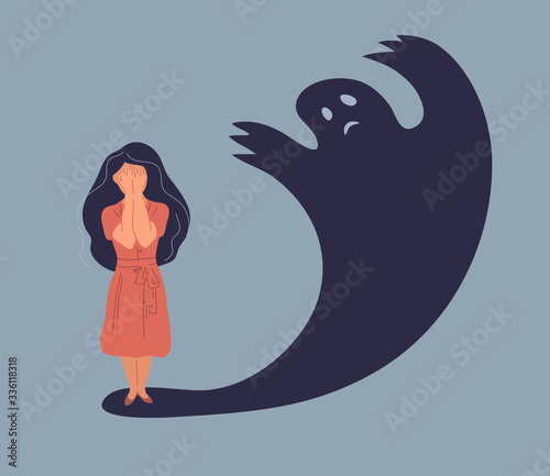 Anxiety or panic attack. Sad young woman with lowered head frightened with his own shadow and having panic disorder