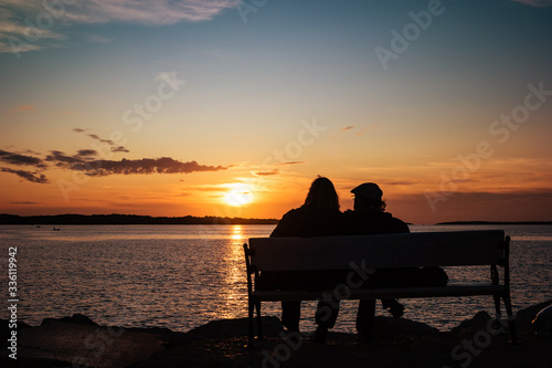 Happy mature couple silhouette at sunset in Fazana, Croatia