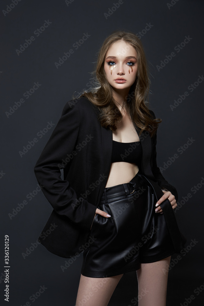 Beauty portrait blonde woman with makeup and big blue eyes, natural cosmetics, clean delicate skin of the girl face, black clothes. Drops of makeup trickle from the girl eyes Beauty portrait blonde woman with makeup and big blue eyes, natural cosmetics, clean delicate skin of the girl face, black clothes. Drops of makeup trickle from the girl eyes