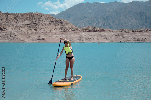 girl on a stand up paddle boarding
