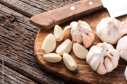 Sliced Garlic and garlic bulb on vintage wooden background. Place for text, copy space. Concept of healthy food.