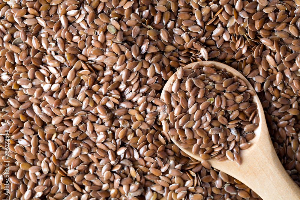 flax seeds and wooden spoon flax seeds and wooden spoon
