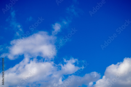 Bright white clouds on blue sky. Spring sunny day. Beautiful nature background.