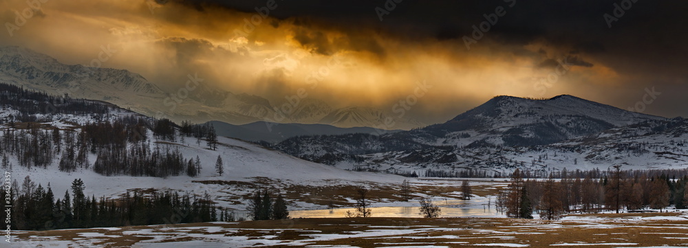 Russia. Gloomy sunset in the Altai mountains. Late autumn at the North-Chuya mountain range in the heart of the kurai steppe.