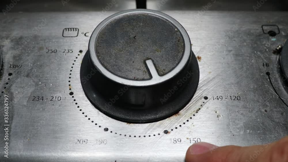 turning the knob on the stove for baking
