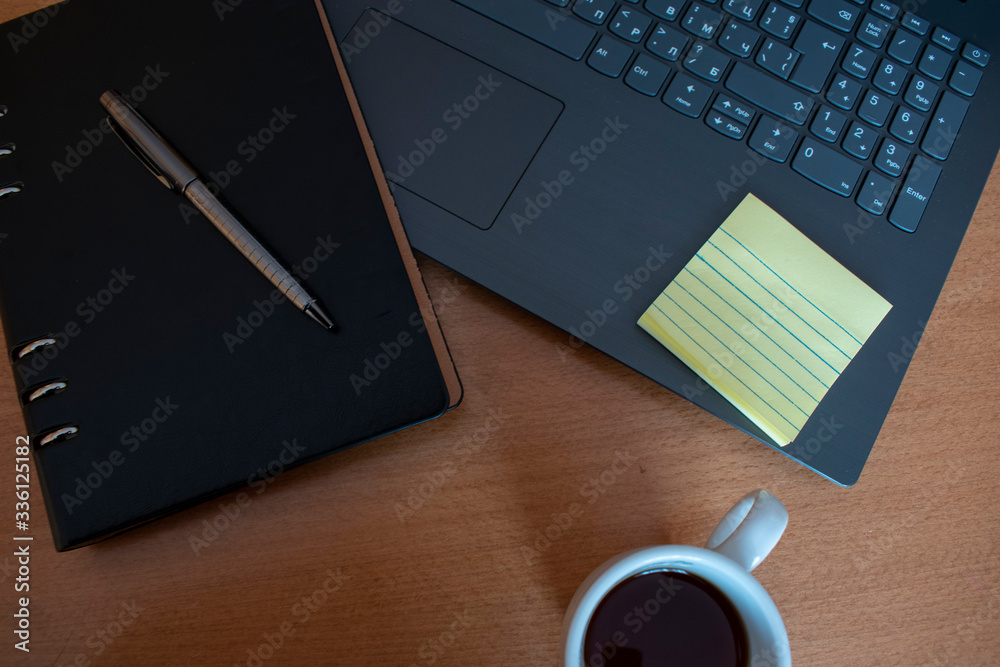 Home office setup, during self-isolation. Keyboard, notebook, pen, coffee, notes. Home office setup, during self-isolation. Keyboard, notebook, pen, coffee, notes.