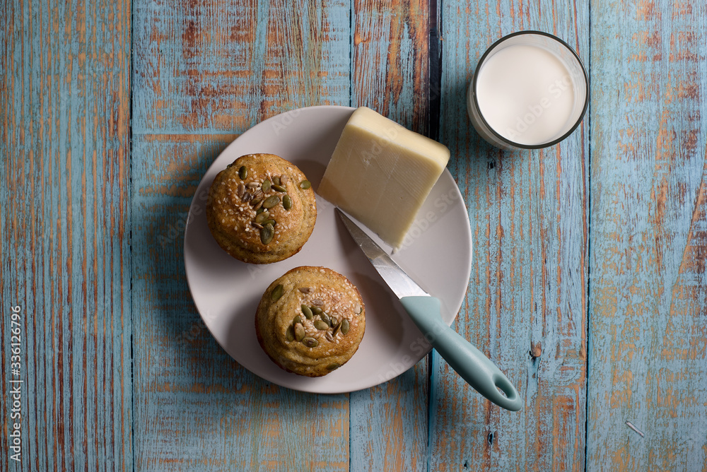 Corn bread made in the form of muffins ( proja ) with sesame and pumpkin seeds with cheese and glass of yogurt. Balkan cuisine. Blue rustic wooden background - Top View Corn bread made in the form of muffins ( proja ) with sesame and pumpkin seeds with cheese and glass of yogurt. Balkan cuisine. Blue rustic wooden background - Top View