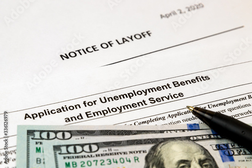 Job layoff notice and application for unemployment insurance benefits paperwork. Concept of Covid-19 coronavirus and stay at home order impact on economy