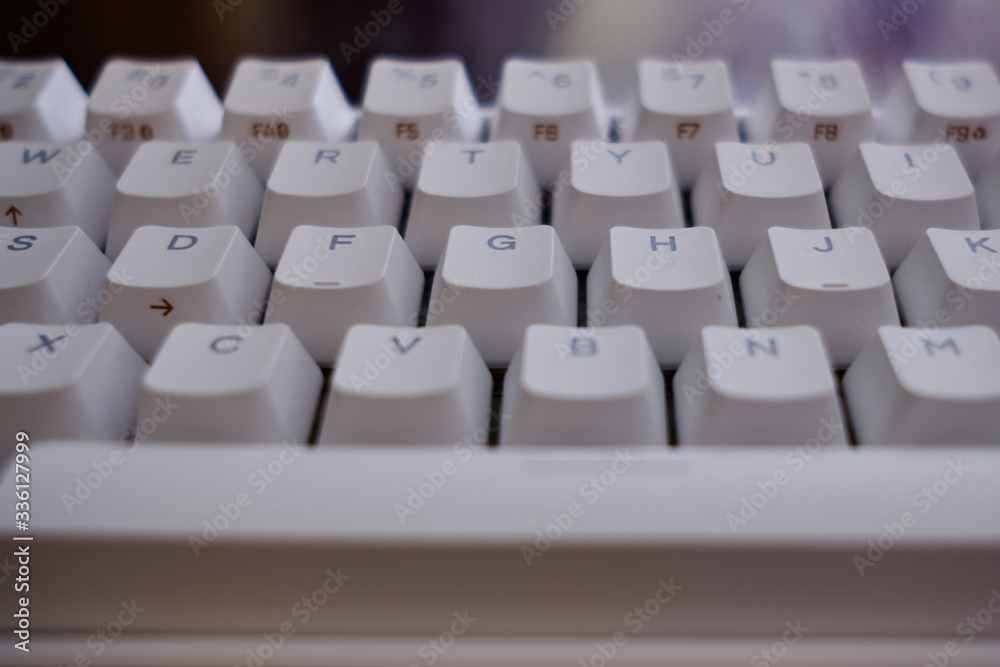 Close and front view of a white mechanical keyboard focused in keys D F G H J Close and front view of a white mechanical keyboard focused in keys D F G H J