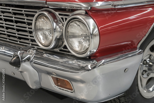 chrome plated shining twin front lights and bumper of vintage car, Wanaka, New Zealand