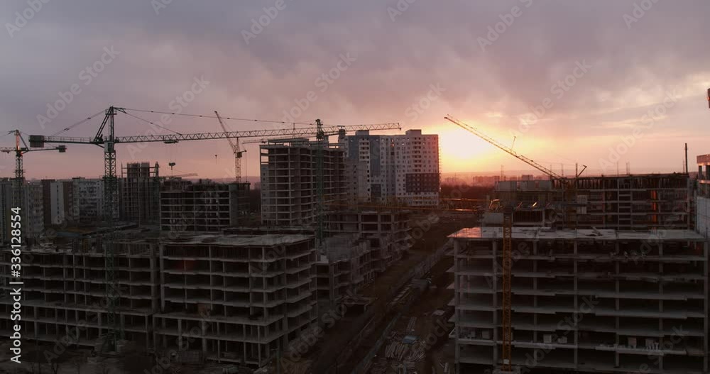 Construction of blocks, buildings in the city, against the background of a sunset. Construction of blocks, buildings in the city, against the background of a sunset.