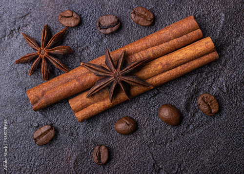 Badyan, cinnamon and coffe grains on a dark concrete background