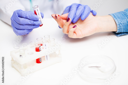Woman at the hospital submits a blood test for a coronavirus